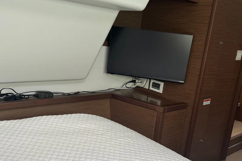 Habzie Yacht Photos Pics Interior of 2019 Lagoon 450 F Owner's Edition with TV and wooden cabinetry.