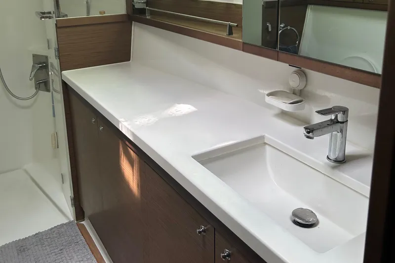 Habzie Yacht Photos Pics Modern bathroom in 2019 Lagoon 450 F Owner's Edition yacht, featuring sleek sink and shower.