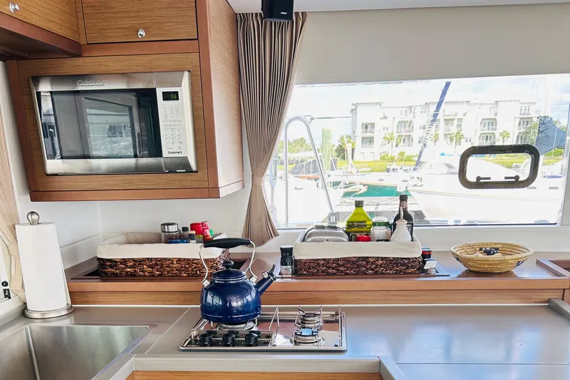 Habzie Yacht Photos Pics Modern kitchen in 2019 Lagoon 450 F yacht with stove, microwave, and window view.