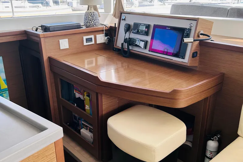 Habzie Yacht Photos Pics Navigation station in 2019 Lagoon 450 F Owner's Edition yacht, featuring modern equipment and wooden finish.