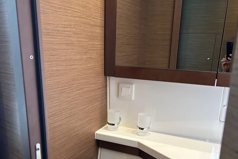 Habzie Yacht Photos Pics 2019 Lagoon 450 F Owner's Edition bathroom with modern fixtures and wood paneling.