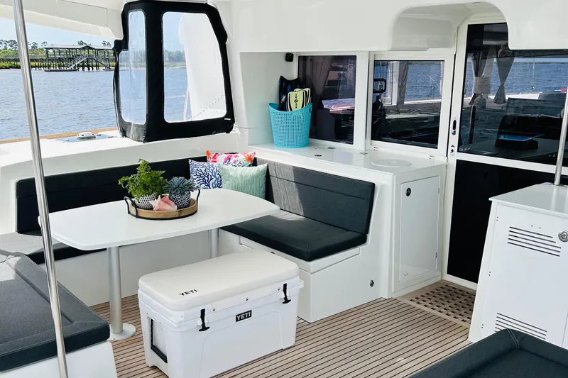 Habzie Yacht Photos Pics Spacious interior of 2019 Lagoon 450 F Owner's Edition catamaran with seating and table.