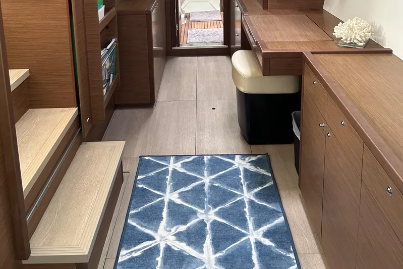 Habzie Yacht Photos Pics Interior of 2019 Lagoon 450 F Owner's Edition yacht with modern wood finish and blue rug.