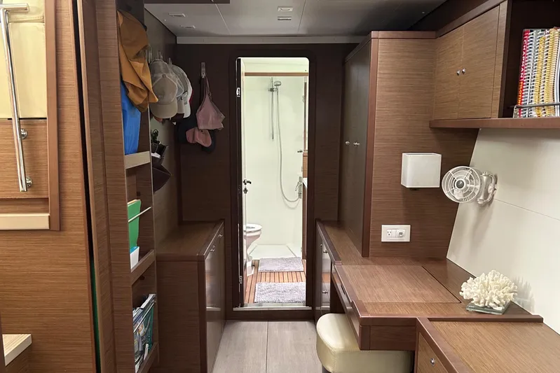 Habzie Yacht Photos Pics Interior of 2019 Lagoon 450 F Owner's Edition yacht, featuring wood cabinetry and compact workspace.