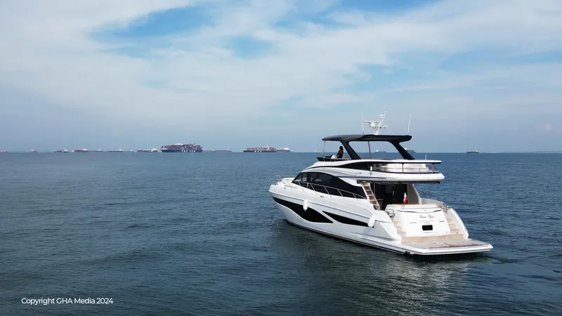  Yacht Photos Pics 2024 Princess F65 yacht cruising on open sea under clear blue sky.