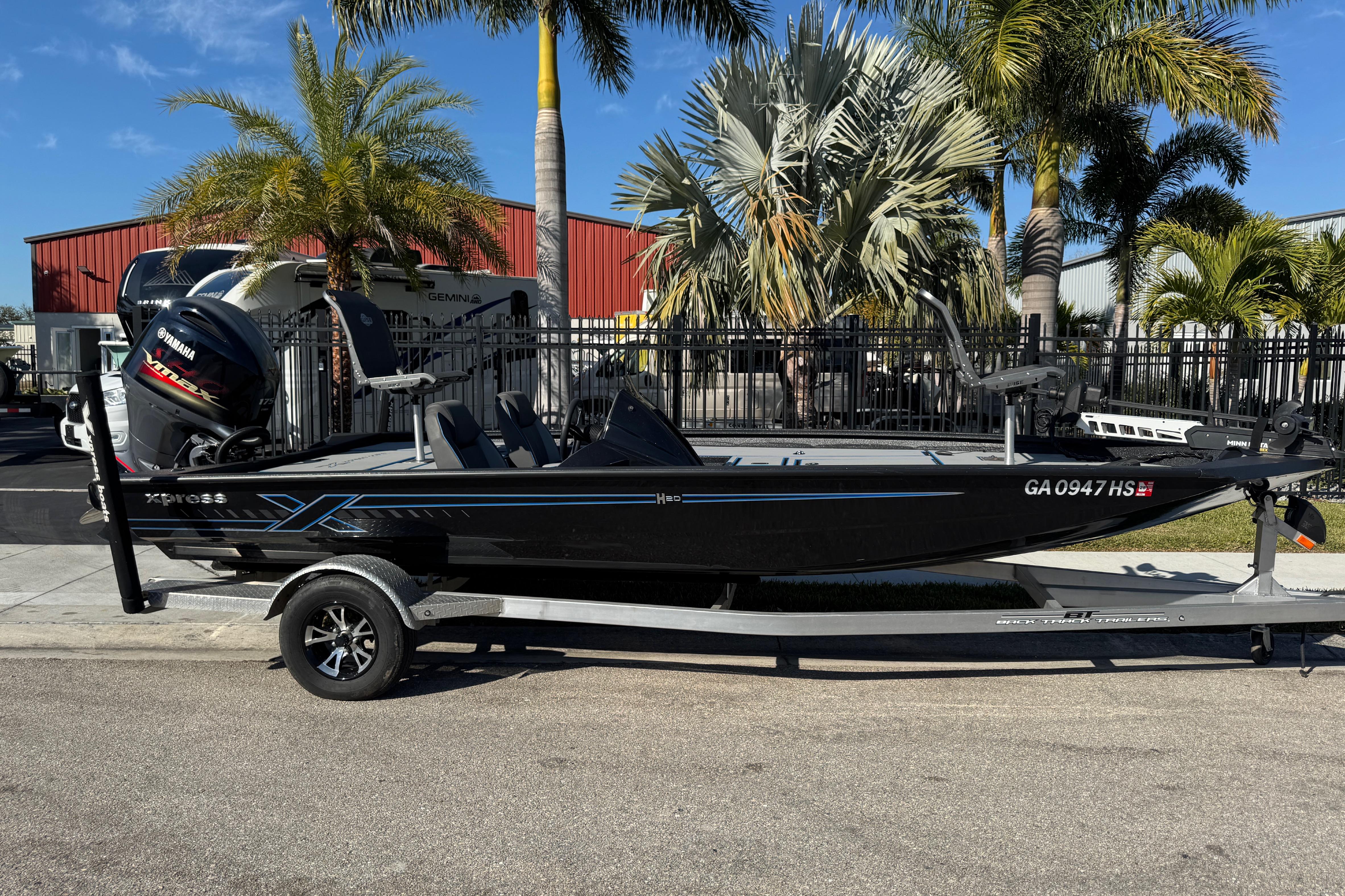 2025 Express H20 boat on trailer, parked near palm trees, with Yamaha motor.
