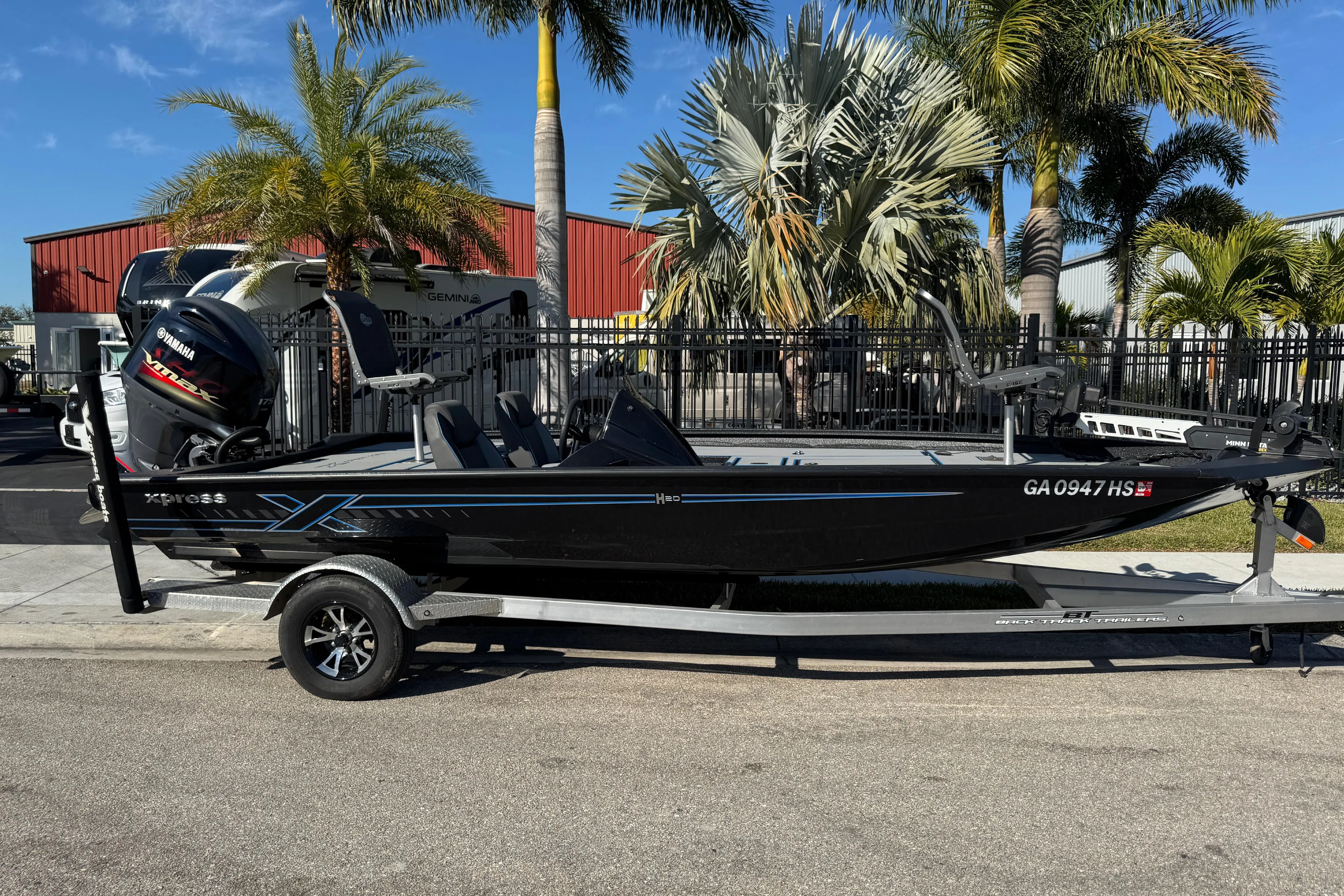 2025 Express H20 boat on trailer, parked near palm trees, with Yamaha motor.