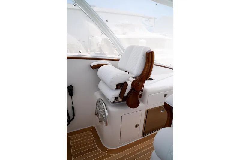 Front Runner Boatworks 47 Walkaround Yacht Photos Pics Captain's chair on 2026 Front Runner 47WA boat, featuring luxurious white upholstery and wooden accents.