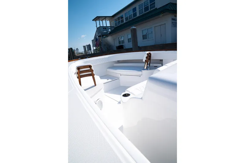 Front Runner Boatworks 47 Walkaround Yacht Photos Pics 2026 Front Runner 47WA boat interior with seating, docked near a building.