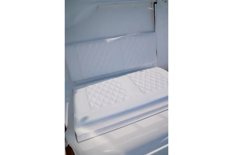 Front Runner Boatworks 47 Walkaround Yacht Photos Pics White cushioned seating on 2026 Front Runner 47WA boat, featuring diamond stitching.