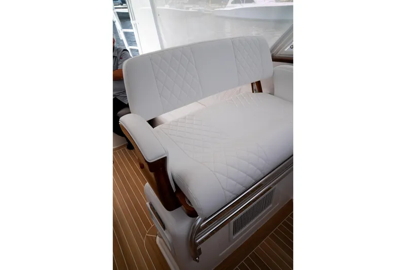 Front Runner Boatworks 47 Walkaround Yacht Photos Pics Luxurious white seating on 2026 Front Runner 47WA boat, featuring quilted design and wooden accents.