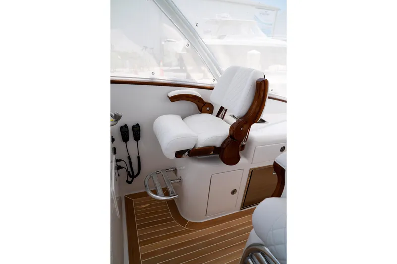 Front Runner Boatworks 47 Walkaround Yacht Photos Pics Captain's chair on 2026 Front Runner 47WA boat, featuring luxurious white upholstery and wooden accents.