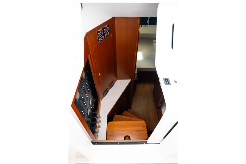 Front Runner Boatworks 47 Walkaround Yacht Photos Pics Interior view of 2026 Front Runner 47WA boat, featuring wooden stairs and control panel.