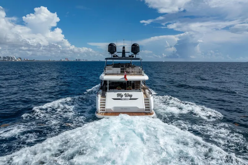  Yacht Photos Pics Sirena 88 yacht cruising on open sea, 2021 model, with city skyline in background.