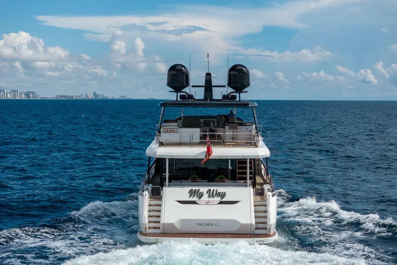  Yacht Photos Pics Luxury Sirena 88 yacht cruising on open sea, 2021 model, with city skyline in background.