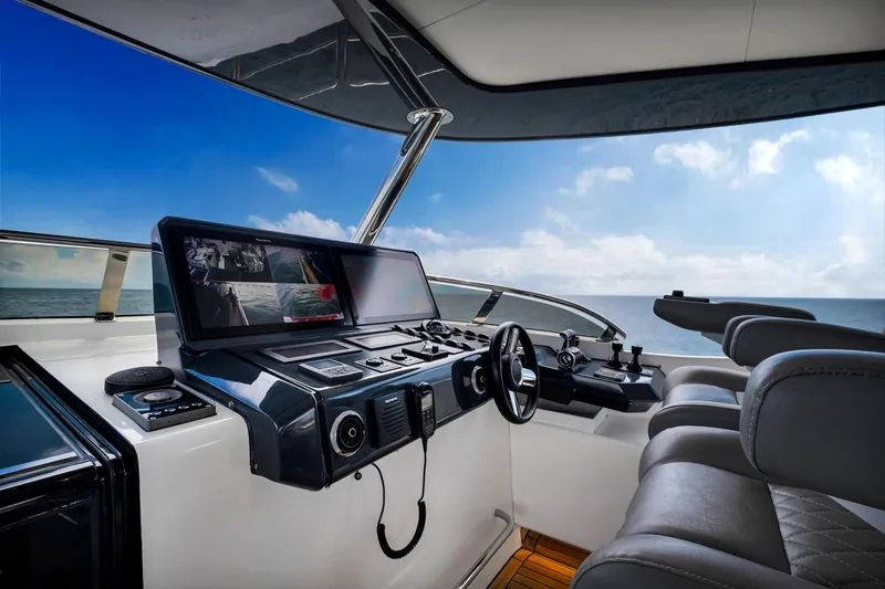  Yacht Photos Pics Helm of 2021 Sirena 88 yacht with modern navigation equipment and ocean view.