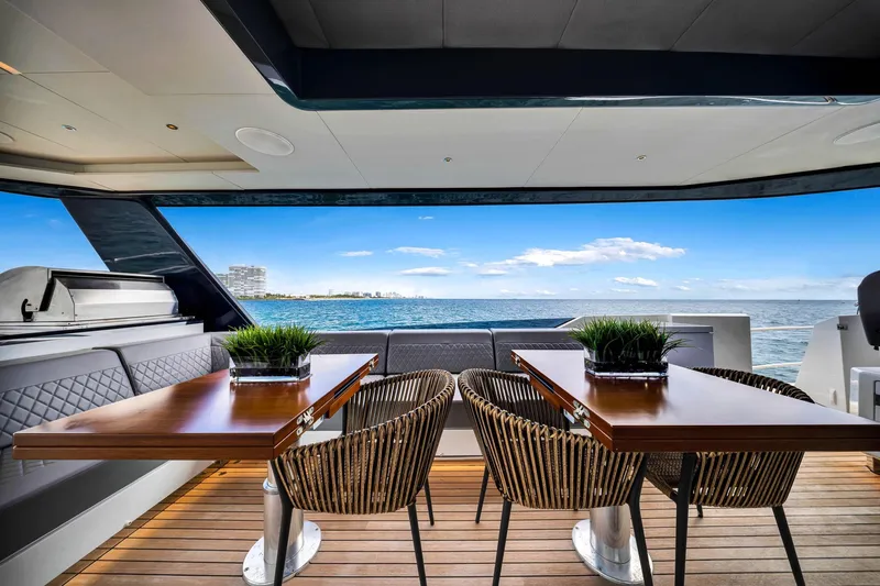  Yacht Photos Pics Luxurious Sirena 88 yacht deck with elegant seating, wooden tables, and ocean view, 2021 model.