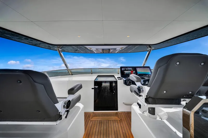  Yacht Photos Pics Interior view of 2021 Sirena 88 yacht helm with modern controls and ocean backdrop.