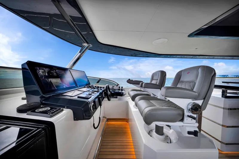  Yacht Photos Pics Luxurious helm of 2021 Sirena 88 yacht with modern controls and plush seating.