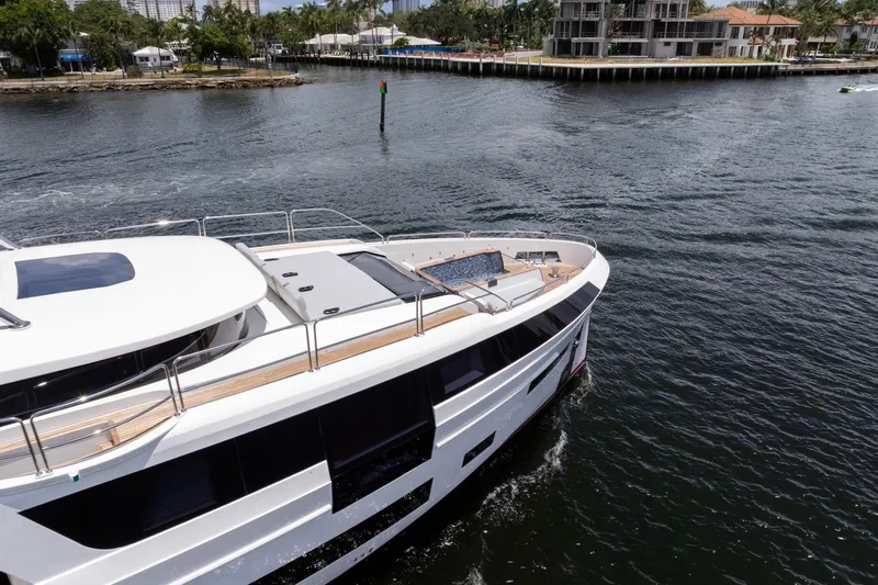  Yacht Photos Pics Luxury Sirena 88 yacht cruising on water, 2021 model, near waterfront homes.