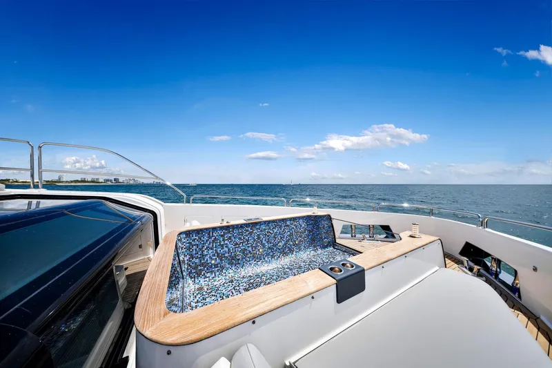  Yacht Photos Pics Luxurious Sirena 88 yacht deck with jacuzzi, ocean view, and clear blue sky, 2021 model.