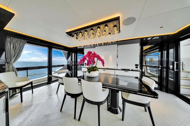  Yacht Photos Pics Luxurious interior of 2021 Sirena 88 yacht with elegant dining area and ocean view.