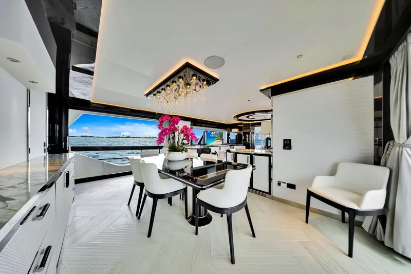  Yacht Photos Pics Luxurious interior of 2021 Sirena 88 yacht with elegant dining area and ocean view.