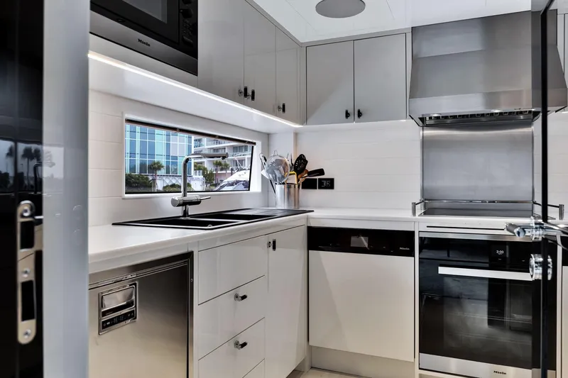  Yacht Photos Pics Modern kitchen interior on Sirena 88 yacht, featuring sleek appliances and minimalist design, 2021 model.