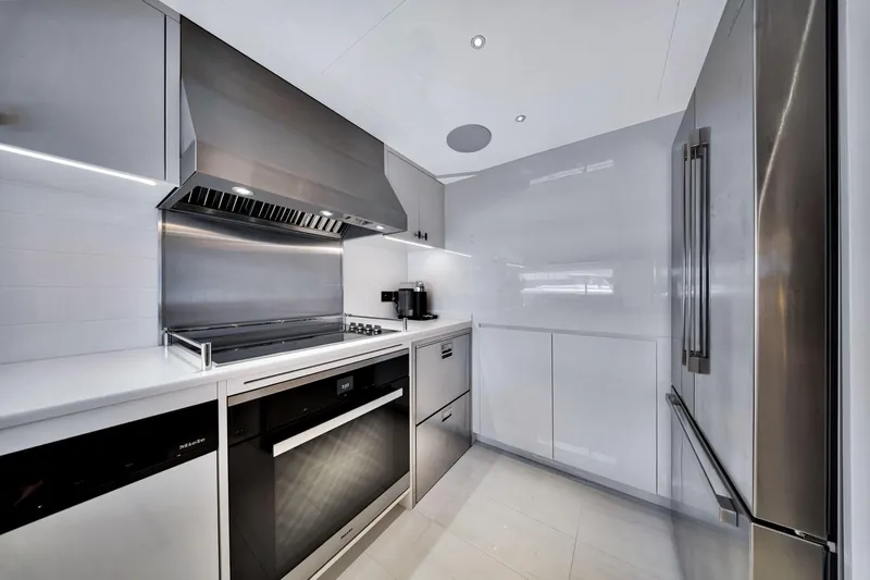  Yacht Photos Pics Modern kitchen interior on 2021 Sirena 88 yacht, featuring sleek stainless steel appliances.