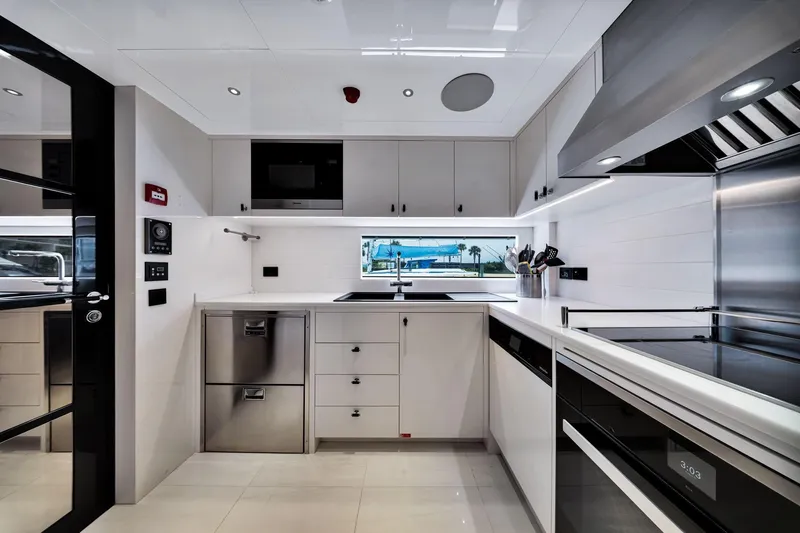  Yacht Photos Pics Modern kitchen interior on 2021 Sirena 88 yacht, featuring sleek appliances and minimalist design.