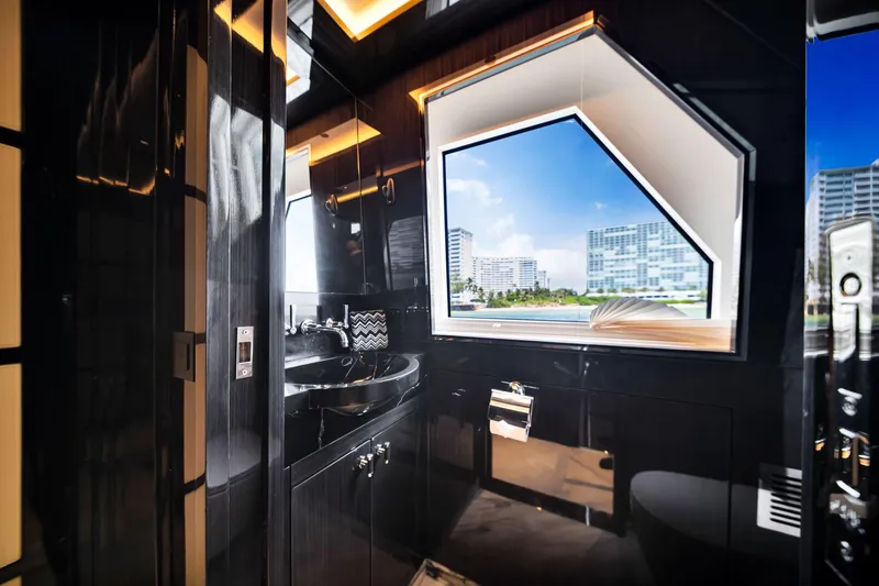  Yacht Photos Pics Luxurious bathroom interior of 2021 Sirena 88 yacht with modern fixtures and large window view.