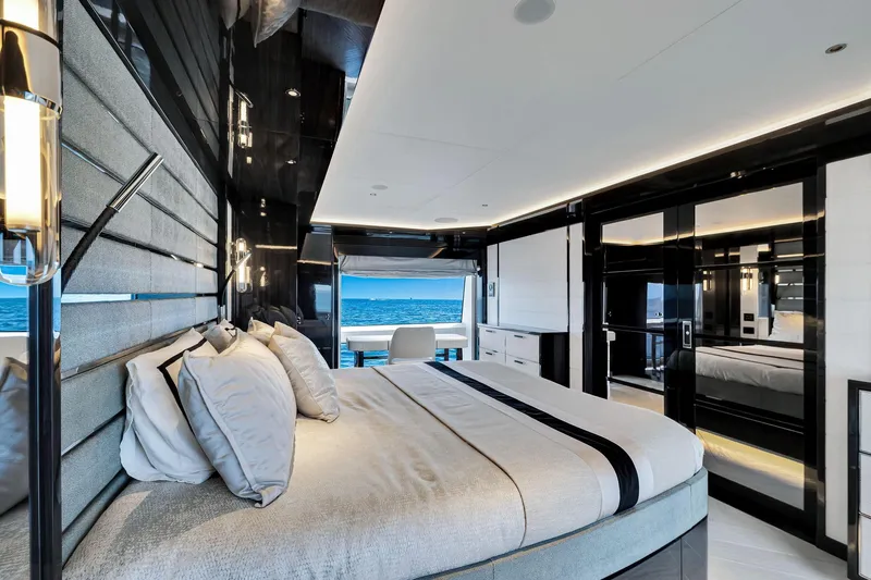  Yacht Photos Pics Luxurious bedroom interior of 2021 Sirena 88 yacht with ocean view.