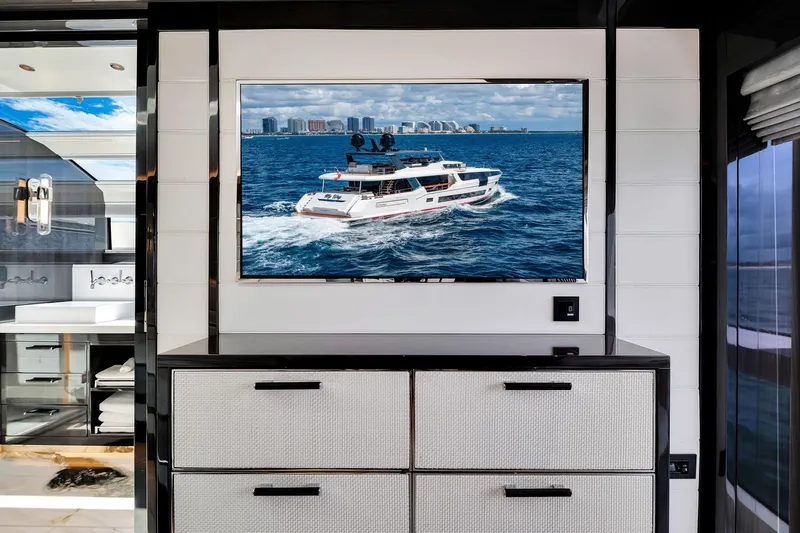  Yacht Photos Pics Interior of Sirena 88 yacht, 2021 model, featuring a wall-mounted TV displaying a yacht at sea.