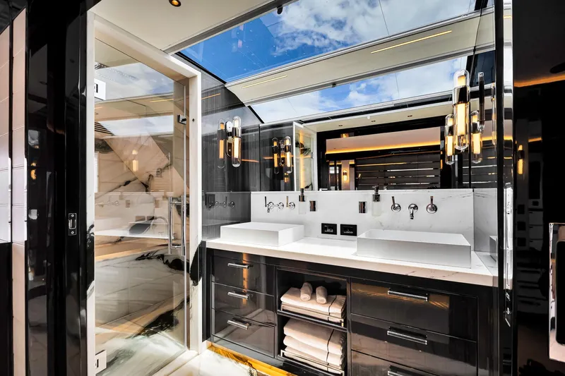  Yacht Photos Pics Luxurious bathroom interior on 2021 Sirena 88 yacht with modern fixtures and skylight.