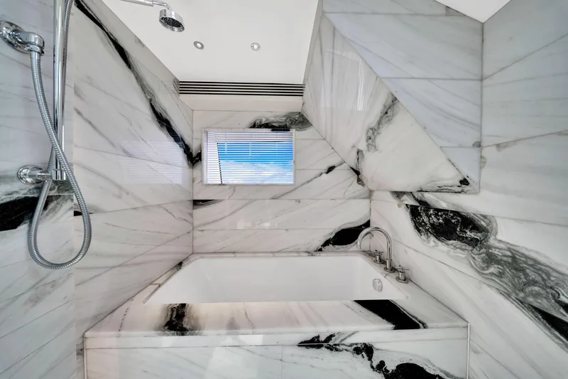  Yacht Photos Pics Luxurious marble bathroom in 2021 Sirena 88 yacht, featuring elegant black and white design.