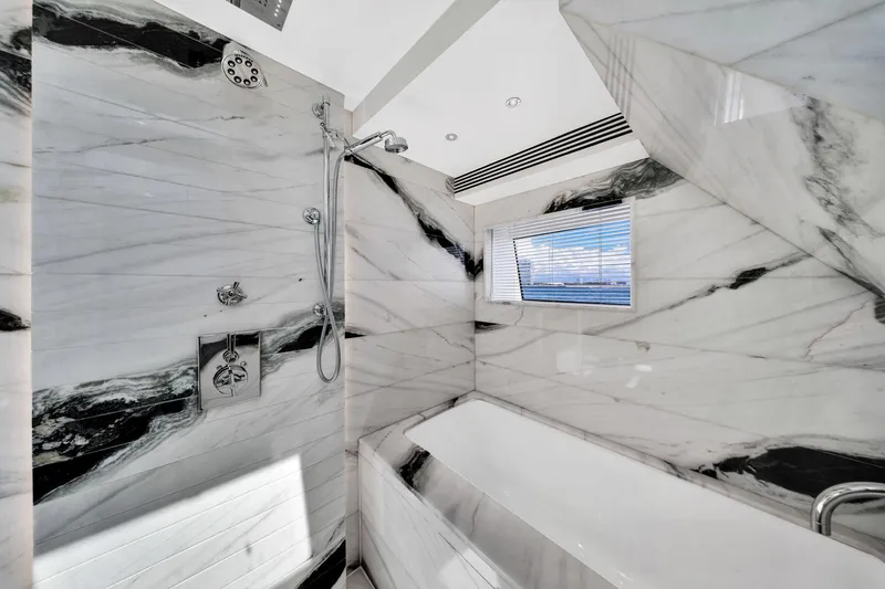  Yacht Photos Pics Luxurious marble bathroom interior on 2021 Sirena 88 yacht, featuring modern shower and bathtub.