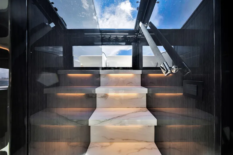  Yacht Photos Pics Luxurious marble staircase with ambient lighting on a 2021 Sirena 88 yacht.