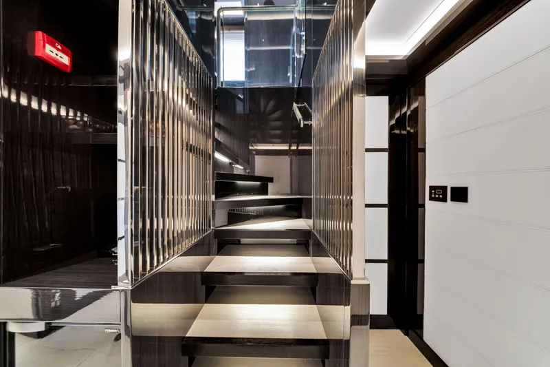  Yacht Photos Pics Modern interior staircase on 2021 Sirena 88 yacht, featuring sleek design and metallic accents.