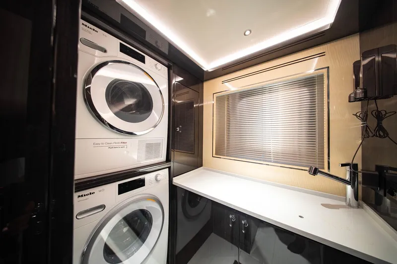  Yacht Photos Pics Laundry room in 2021 Sirena 88 yacht with stacked Miele washer and dryer.