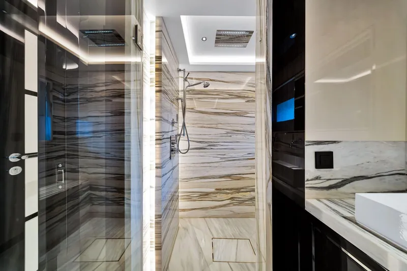  Yacht Photos Pics Luxurious marble bathroom interior on a 2021 Sirena 88 yacht, featuring modern shower design.