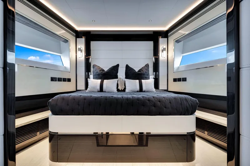  Yacht Photos Pics Luxurious bedroom interior of 2021 Sirena 88 yacht with modern design and large windows.