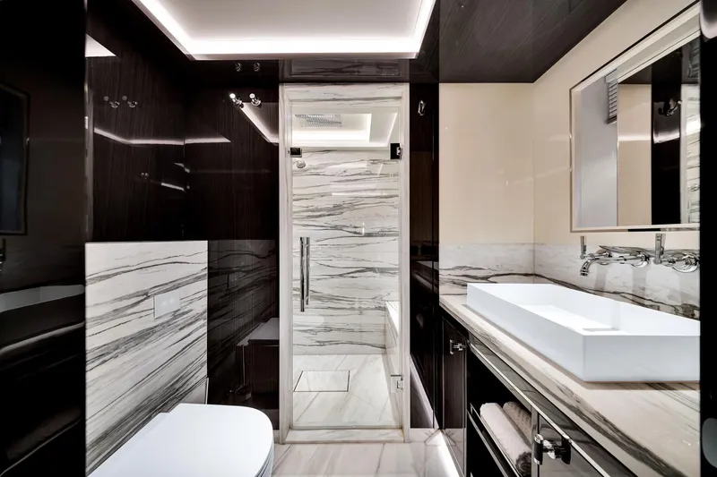  Yacht Photos Pics Luxurious bathroom in 2021 Sirena 88 yacht, featuring sleek marble and modern fixtures.