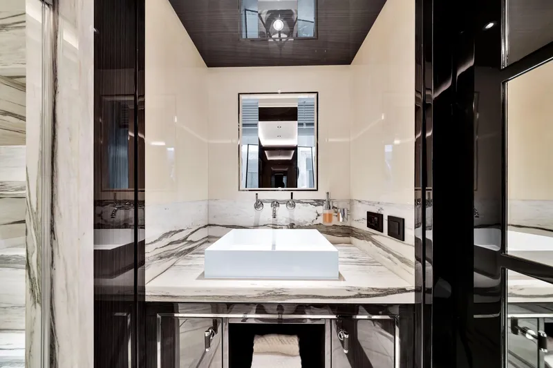  Yacht Photos Pics Luxurious bathroom in 2021 Sirena 88 yacht with marble countertops and modern fixtures.