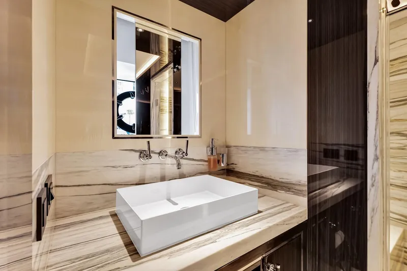  Yacht Photos Pics Luxurious bathroom in 2021 Sirena 88 yacht with modern sink and elegant marble accents.