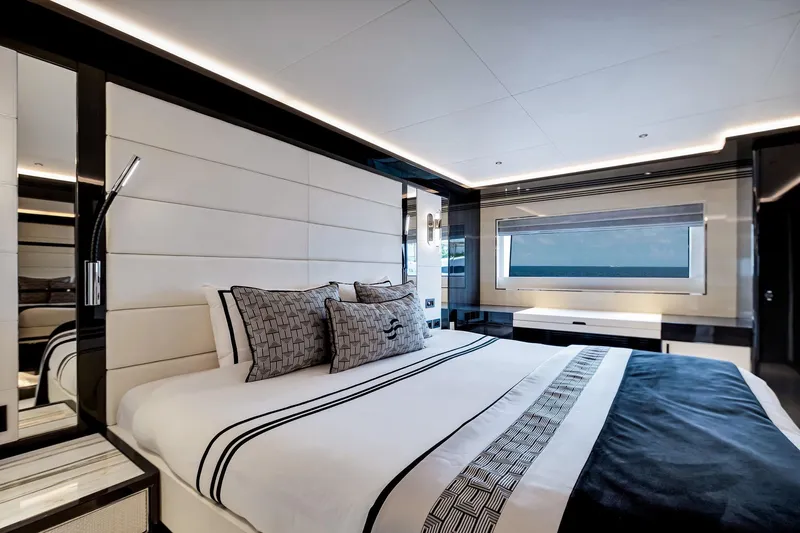  Yacht Photos Pics Luxurious bedroom interior of 2021 Sirena 88 yacht with modern design and ocean view.