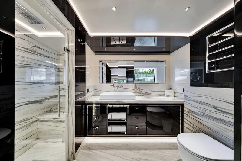  Yacht Photos Pics Luxurious bathroom in 2021 Sirena 88 yacht with marble accents and modern fixtures.