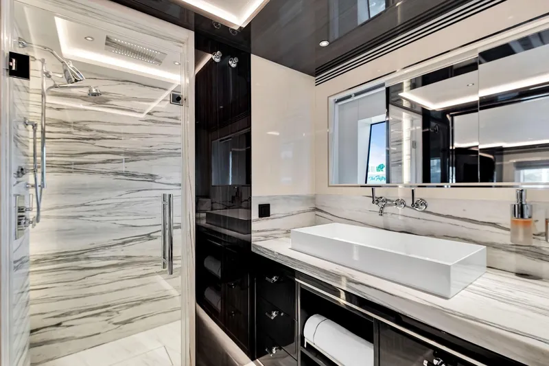  Yacht Photos Pics Luxurious bathroom in 2021 Sirena 88 yacht with marble accents and modern fixtures.