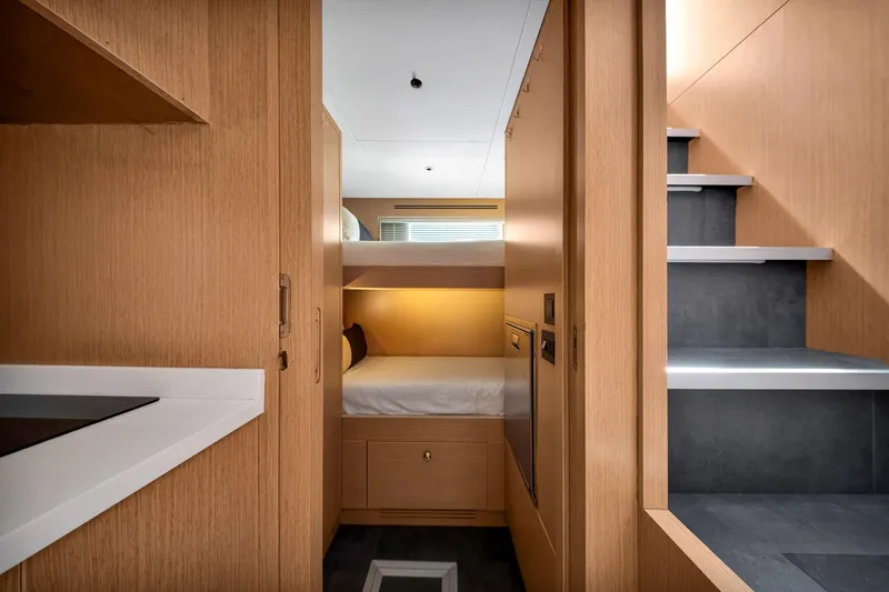  Yacht Photos Pics Luxurious interior of 2021 Sirena 88 yacht featuring modern wood finishes and cozy sleeping area.