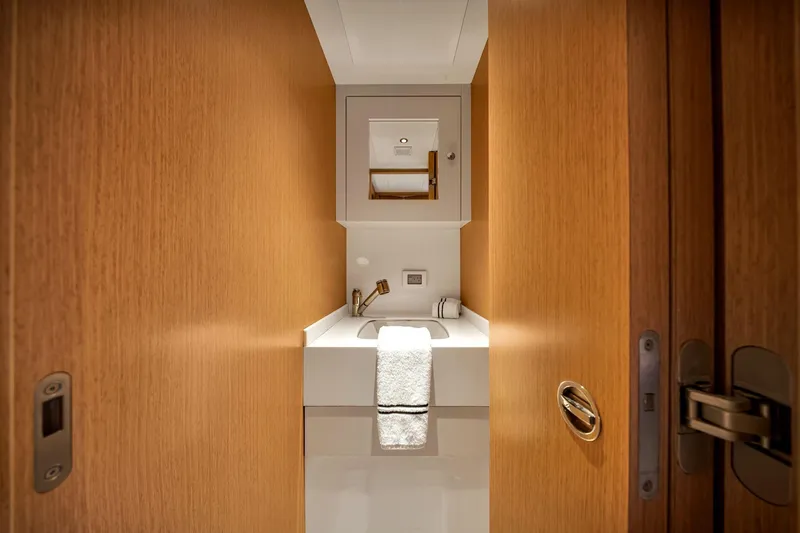  Yacht Photos Pics Luxurious bathroom interior on 2021 Sirena 88 yacht, featuring sleek wood paneling and modern fixtures.