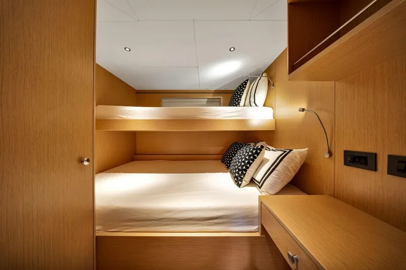  Yacht Photos Pics Interior of 2021 Sirena 88 yacht cabin with bunk beds and modern wood finish.